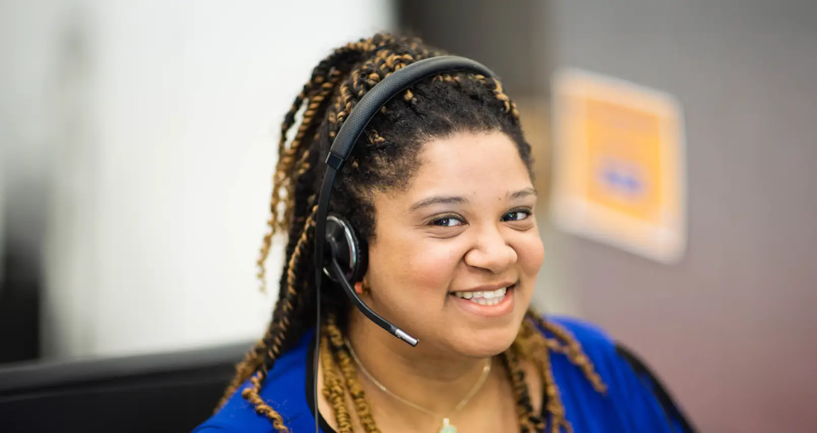 young woman wearing a headset, smiling